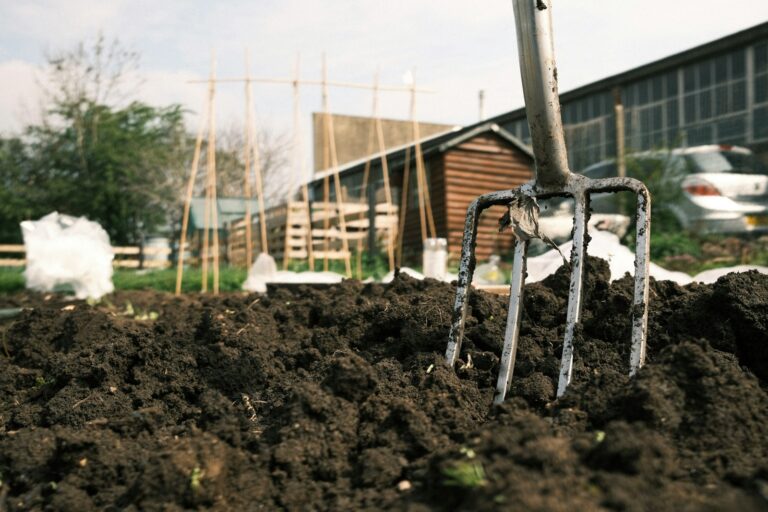 Hand turning compost pile garden fork